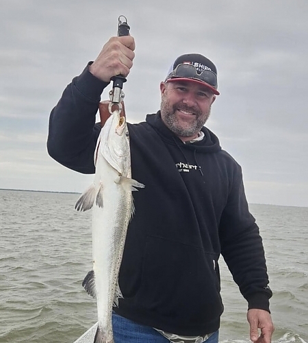  Man holding up fish caught by the tail